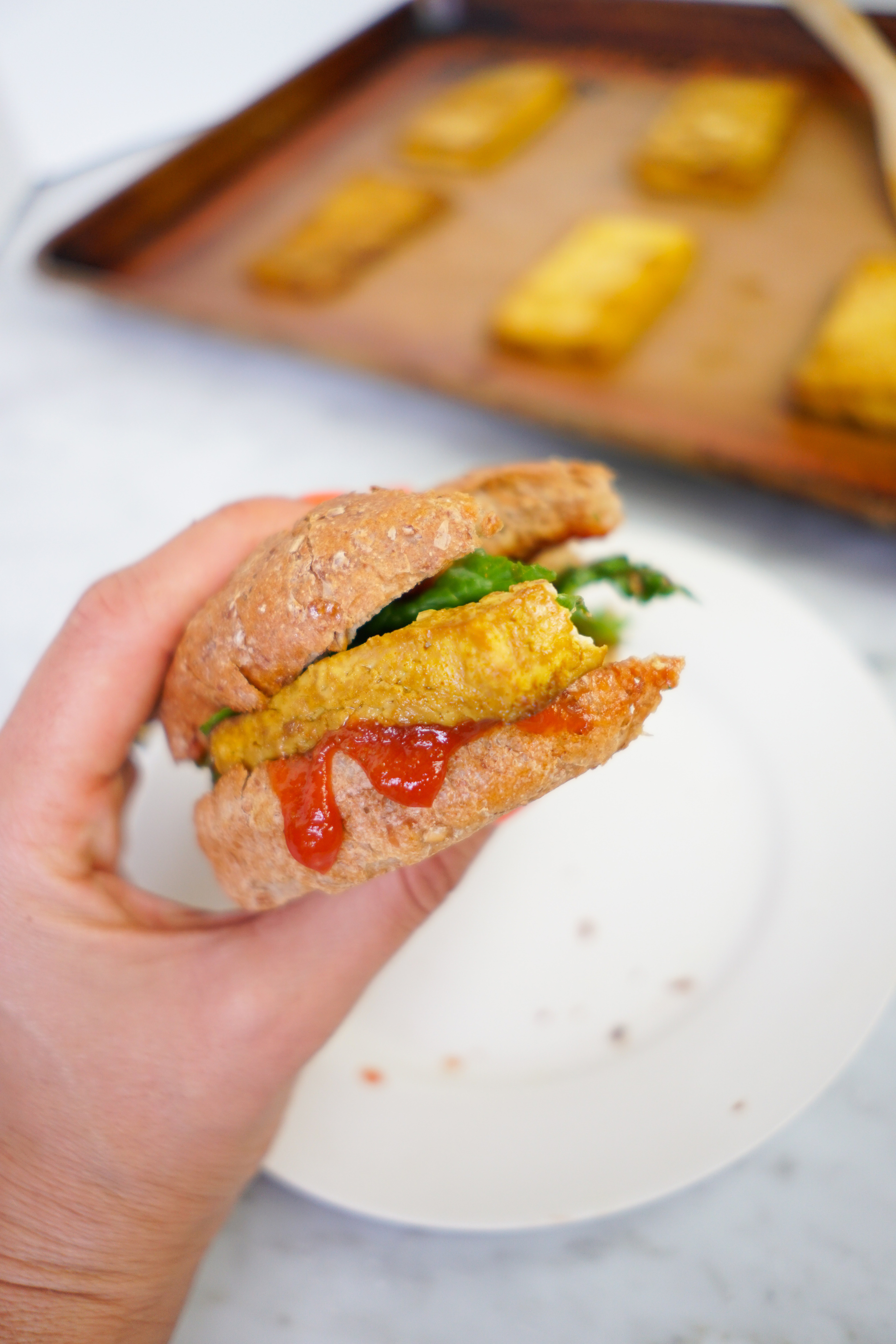 vegan tofu egg sandwich with a bite