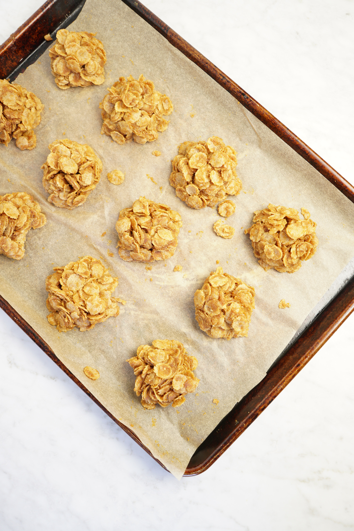 Peanut butter pumpkin cornflake clusters on a pan